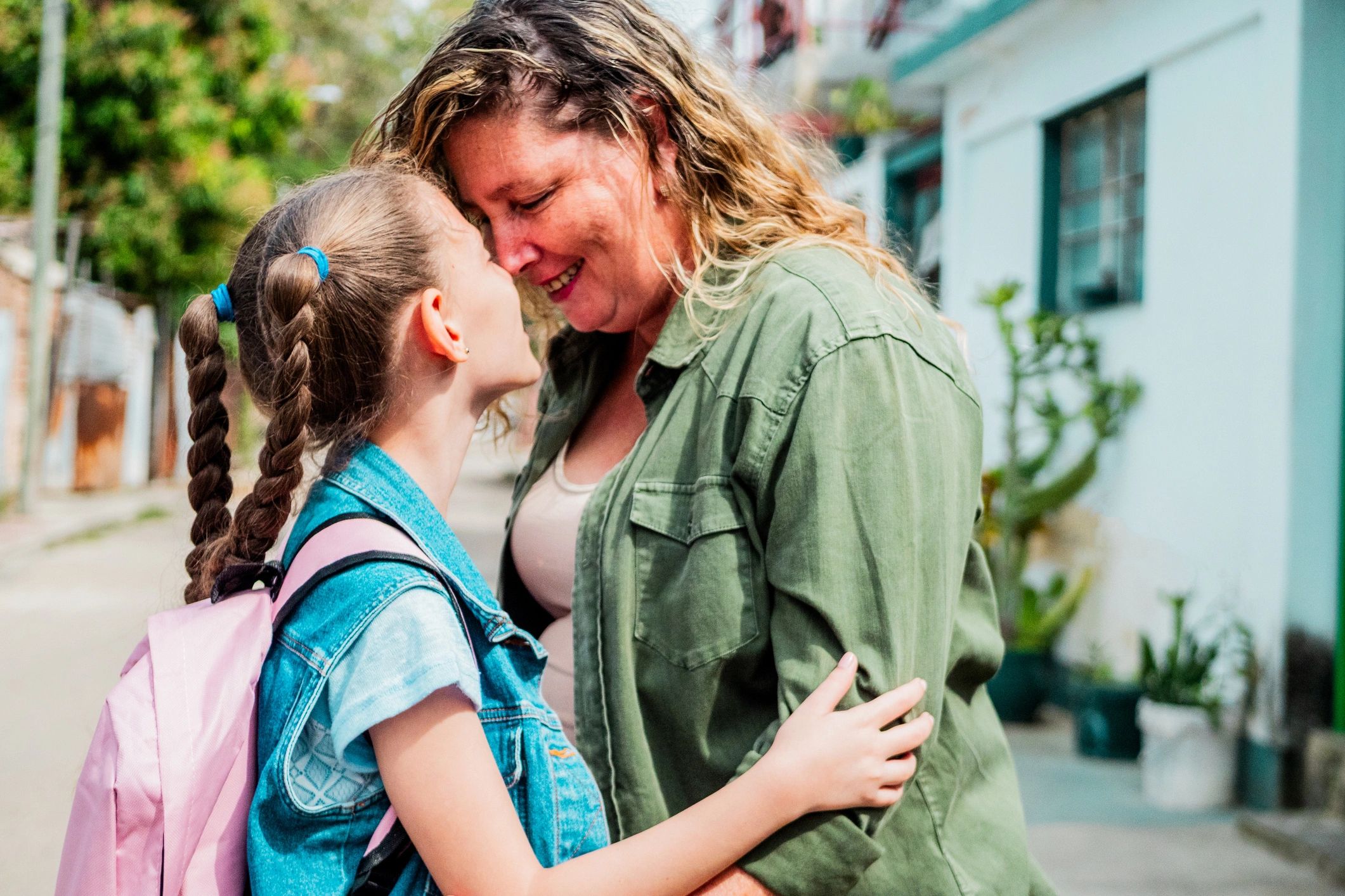 Parent and child sharing a warm moment outdoors
