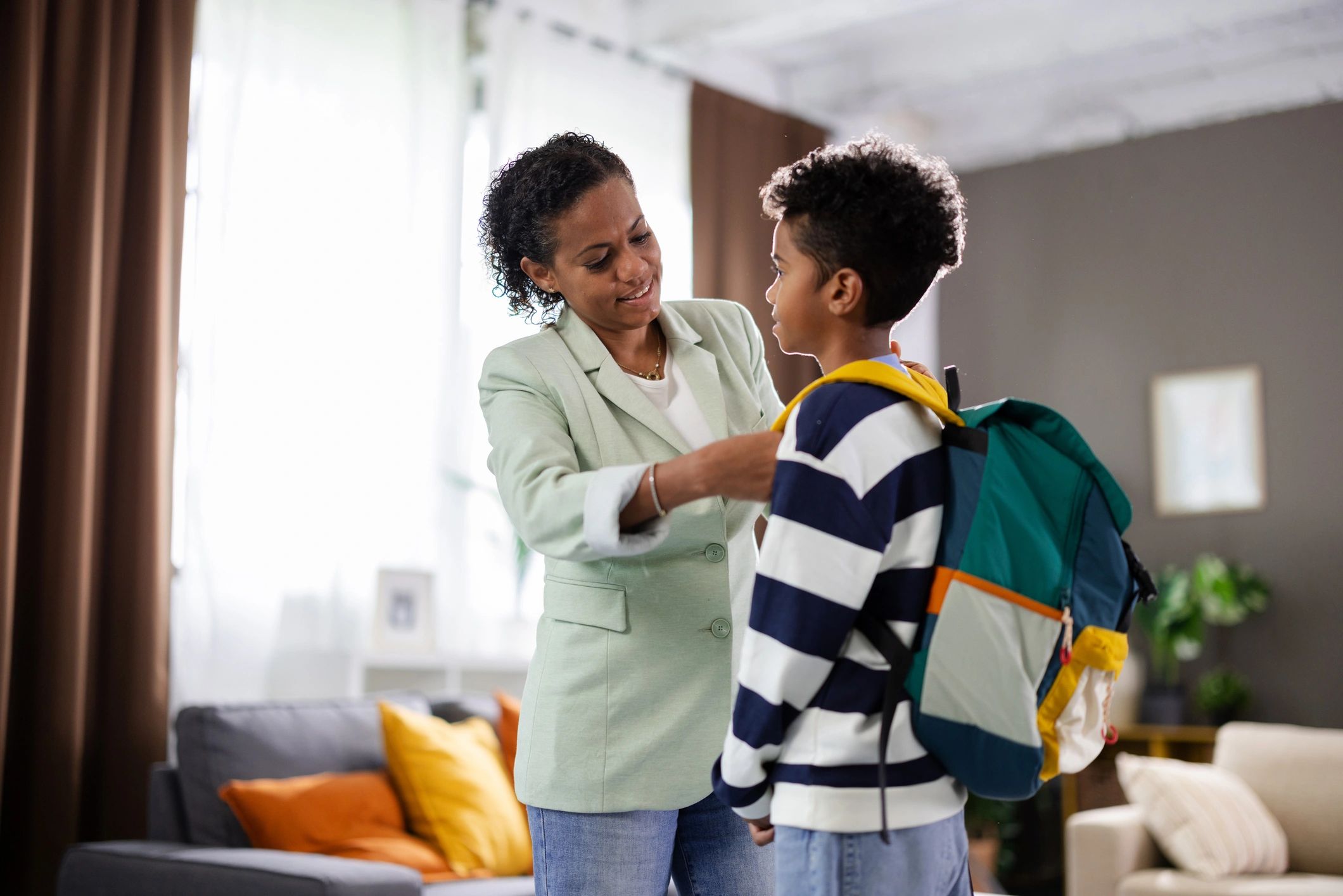 Mother helping child get ready for school