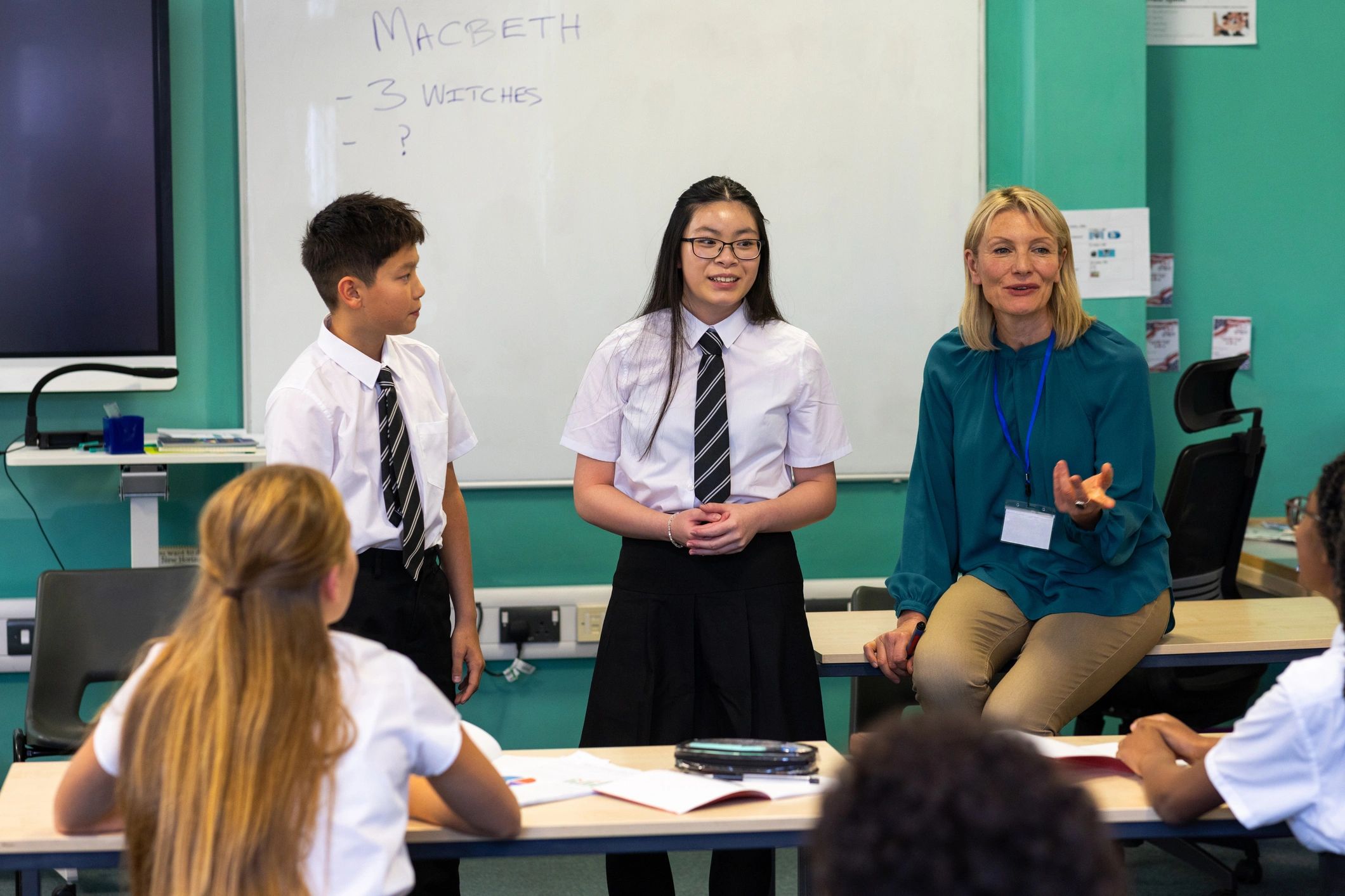 Teacher and elementary students learning together in a bright classroom