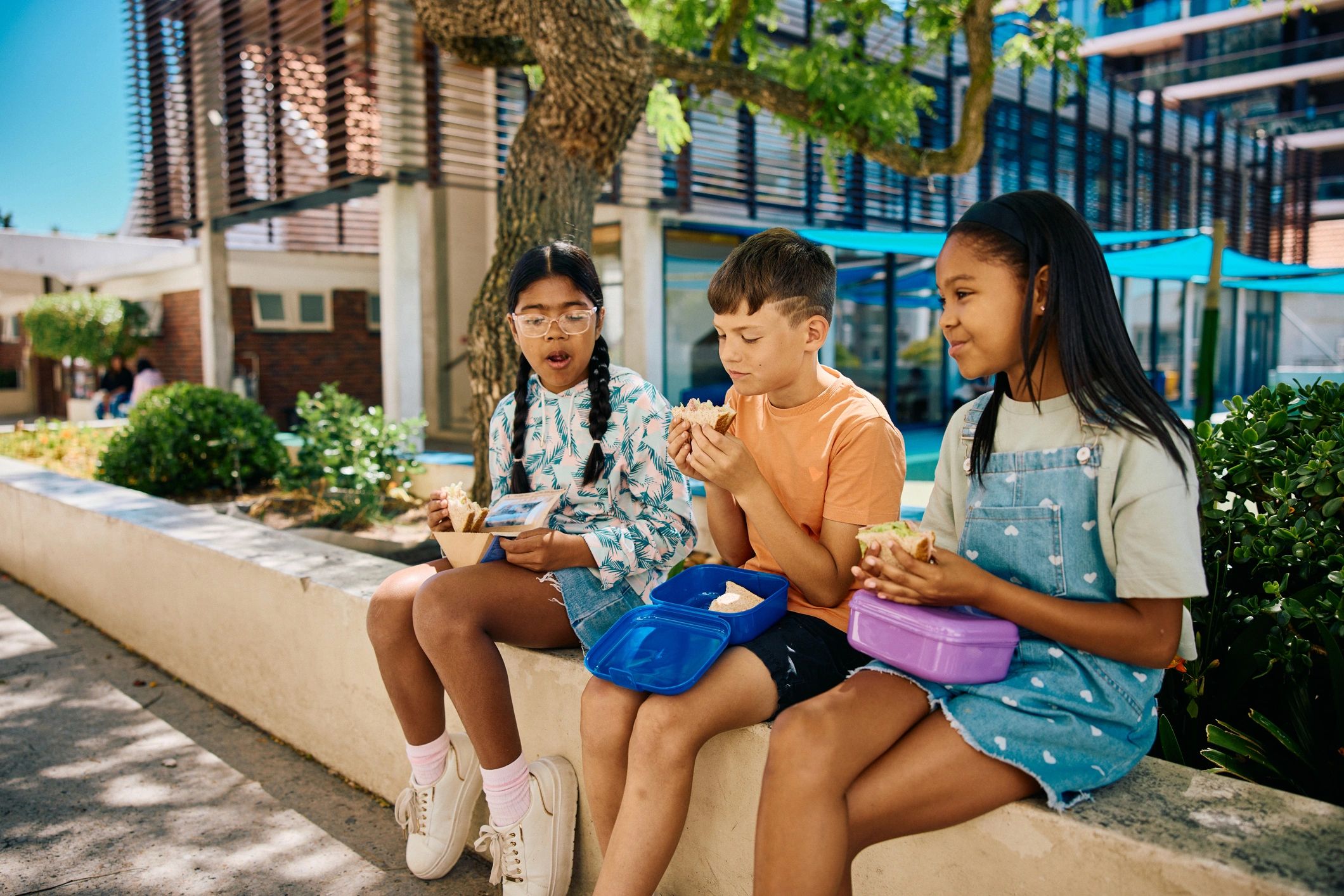 School children spending time together outdoors near the school building