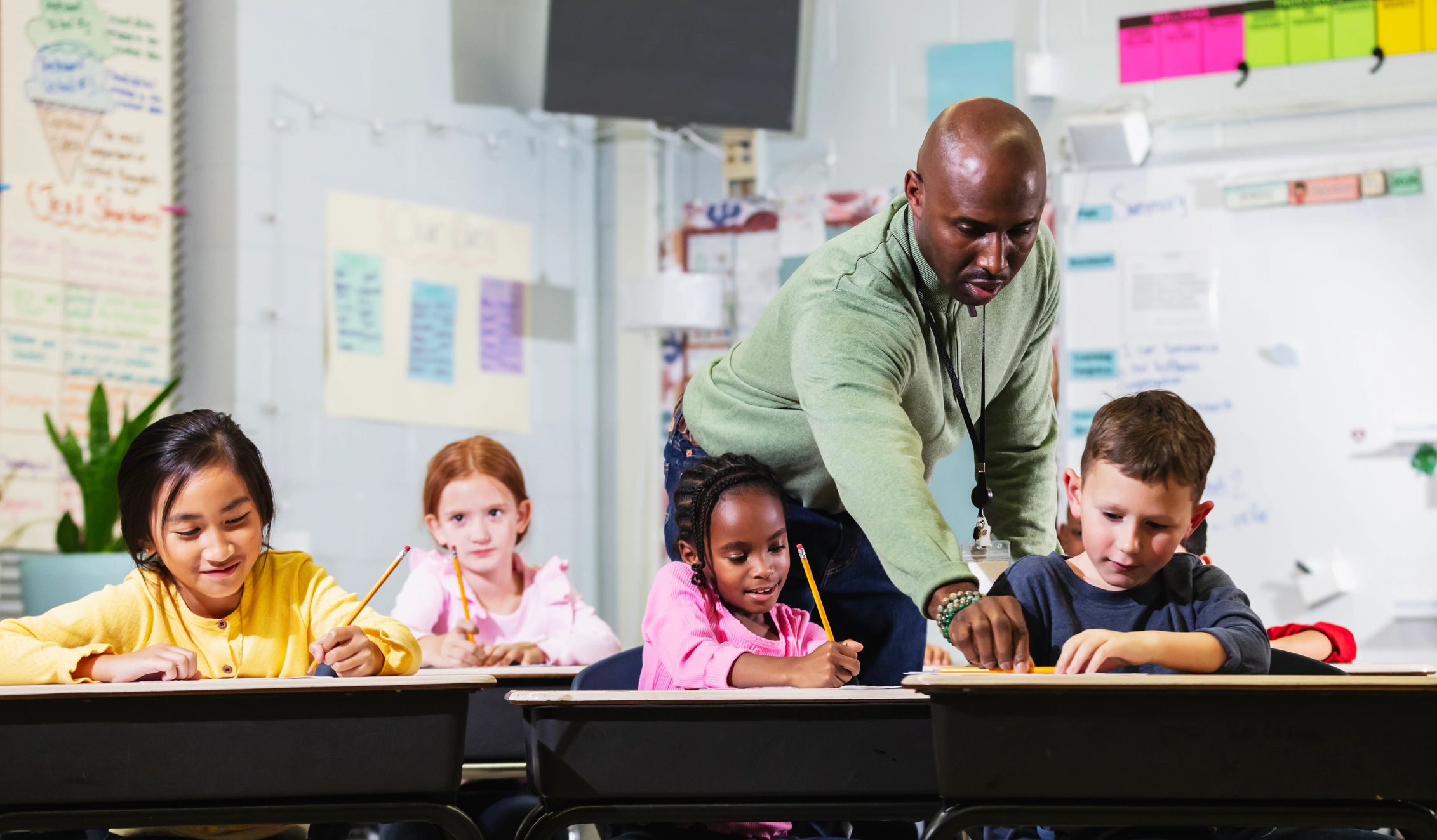 Teacher supporting elementary students in the classroom