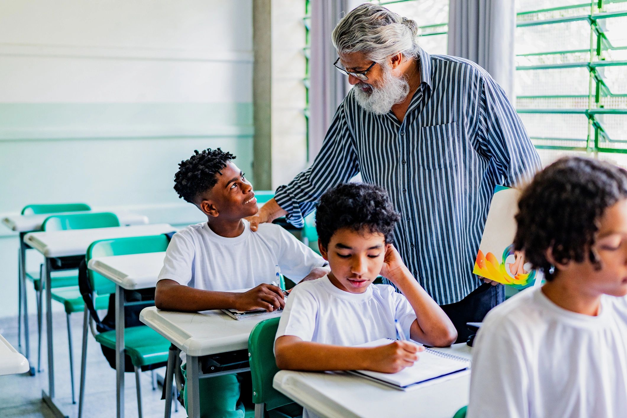 Teacher supporting a student during classroom learning