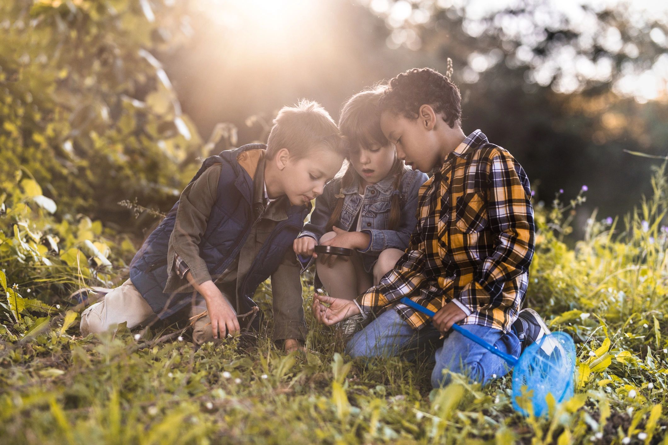 Children examining a flower during hands-on nature study